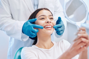 Woman looking in a mirror during a dental consultation.